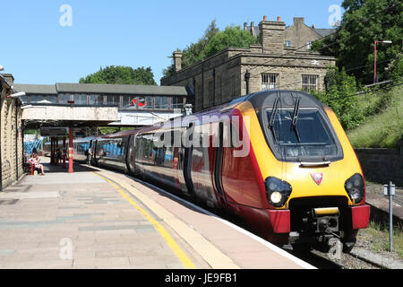 Virgin West Coast liveried super voyager class 221 diesel multiple unit train in Lancaster railway station platform 5 on the West Coast Main Line. Stock Photo