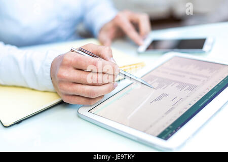 Accounting on a tablet computer, close-up Stock Photo