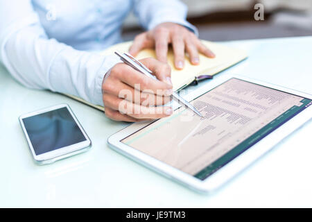 Accounting on a tablet computer, close-up Stock Photo