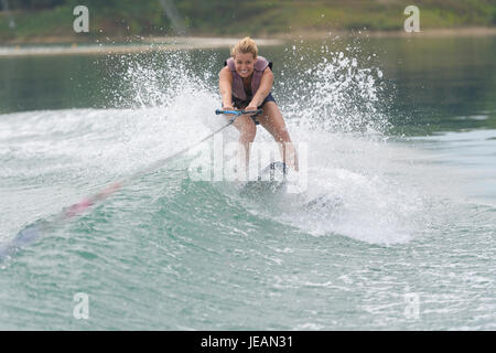 young woman study riding wakeboarding on a lake Stock Photo