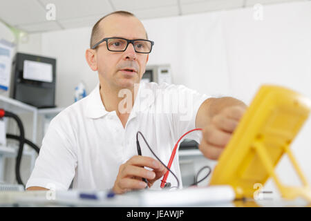 electrician working on an electric meter Stock Photo