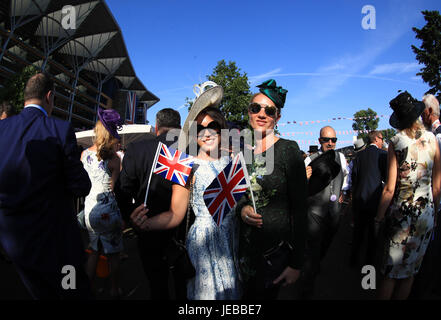 Female racegoers wave Union Jack Flags during day two of Royal Ascot Stock Photo