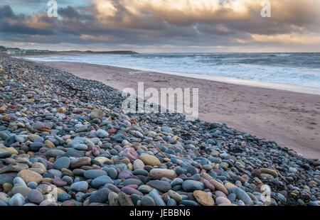 Cold Winter day with dramatic sky, pebble and sandy empty beach, Thorntonloch, East Lothian, Scotland, UK Stock Photo