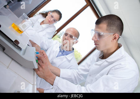 young caucasian scientists studying a molecular structure in a laboratory Stock Photo