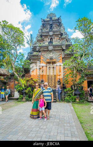 BALI, INDONESIA - APRIL 05, 2017: Unidentified people posing in Puri Kantor a Hindu temple in the center of Ubud, Bali, Indonesia. Stock Photo