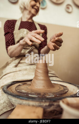 Front view of female craftsman working on potters wheel Stock Photo