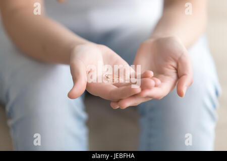 Close up image of golden ring in womans hands Stock Photo
