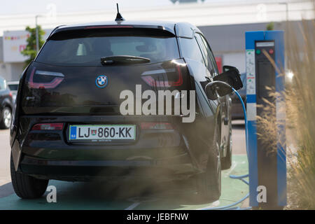 Ljubljana, Slovenia - June 21, 2017: i3 BMW electric car being charged at electric car charging station on 21th of June, 2017 in Ljubljana. Stock Photo