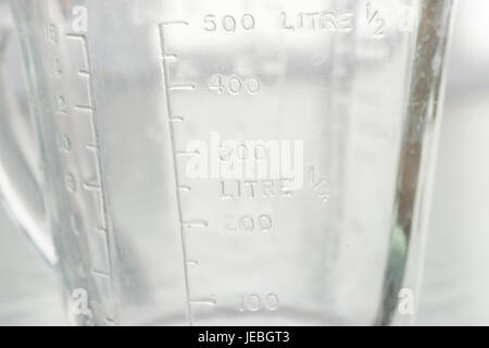 Measuring mug on a white background Stock Photo