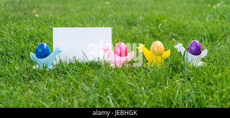 Colorful Easter eggs in egg cups with copy space Stock Photo