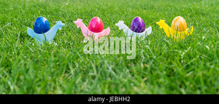 Colorful Easter eggs in egg cups Stock Photo