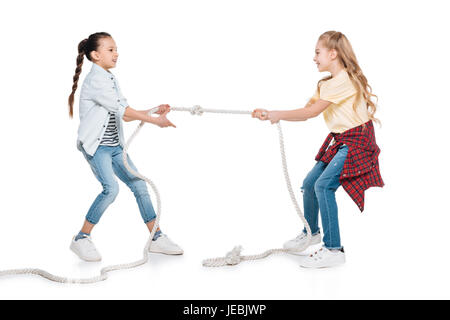 Two girls play tug of war, kids sport isolated concept Stock Photo