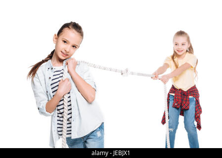 Two girls play tug of war, kids sport isolated concept Stock Photo