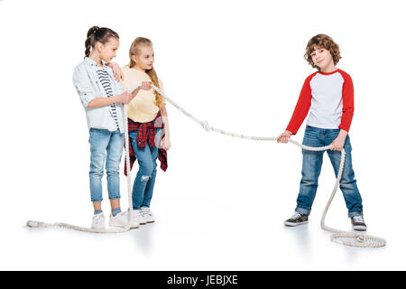 Children play tug of war, boy vs girls, kids sport isolated concept Stock Photo