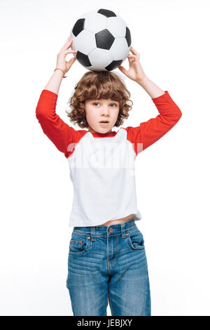 Little boy hold soccer ball over head, children sport concept Stock Photo