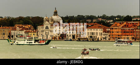 Traffic on the Grand Canal in Venice Italy, early morning. There are ferries, water taxis barges,police boats. All traffic is on the water no streets Stock Photo