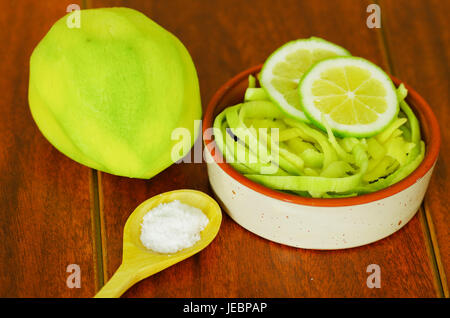 Close up shot of small sliced mango served with salt and lemon on a plate Stock Photo