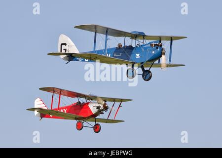 1925 DH60 Cirrus Moth flying alongside 1929 Southern Martlet Old Warden Aerodrome Stock Photo