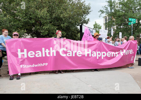 Several hundred people held a protest rally outside the US Cellular Center in Cedar Rapids during a presidential visit by Donald Trump. Stock Photo