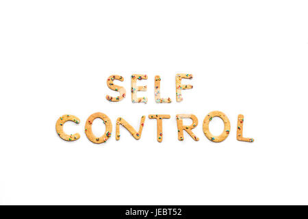 Top view of self control lettering made from candies isolated on pink ...