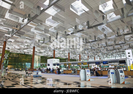 Passengers at Singapore Changi airport terminal 4 departures counter self  check in area Stock Photo - Alamy