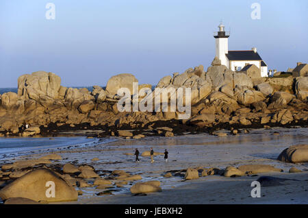 Europe, France, Brittany, Finistere, person on the beach of Brignogan, lighthouse in the background, Stock Photo