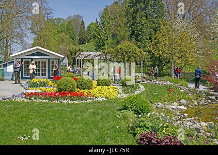 Germany, Baden-Wurttemberg, island Mainau, tourist, Lake of Constance, spring, model garden, spring flowers, tulips, pansies, narcissi, garden pond, pond, cherry trees, blossom, people, Stock Photo
