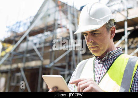 Architect On Building Site Using Digital Tablet Stock Photo