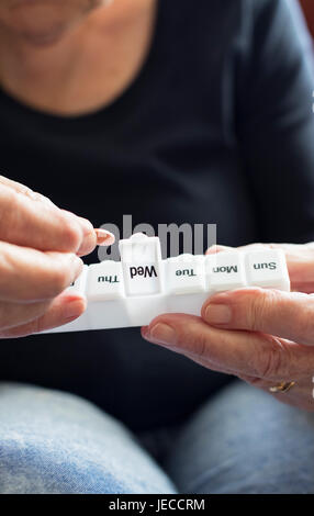 Senior Woman Taking Medication From Pill Box Stock Photo