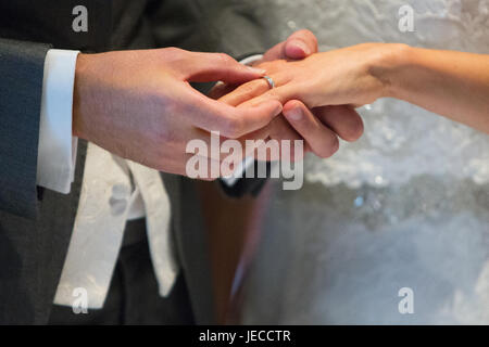 Couple Getting Married And Putting The Ring On Each Others Finger Stock 