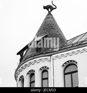 travel to Latvia - cat figure on turret rooftop of Cat House in Riga city in autumn. Palace was built in 1909, designed by architect Friedrich Scheffe Stock Photo
