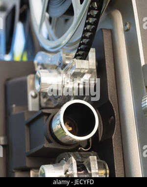 A large film reall is mounted on a vintage Super 8 movie projector Stock Photo