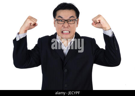 Angry Asian Chinese man wearing suit and holding both fist in isolated white background. Stock Photo