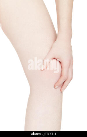 Young woman holds her hand on knee, pain isolated on white, clipping path Stock Photo