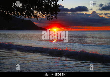Sea Tongues of fire at sunset in Mahe Stock Photo