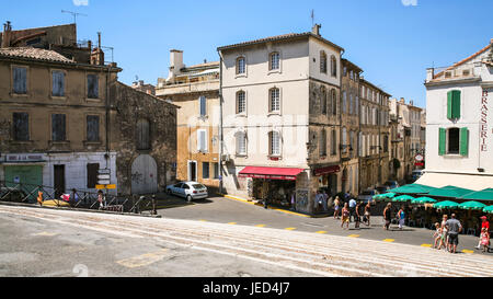 ARLES, FRANCE - JULY 9, 2008: tourists near gift shops on square of Arenes in Arles city. Arles is ancient city and commune on the south of France in  Stock Photo