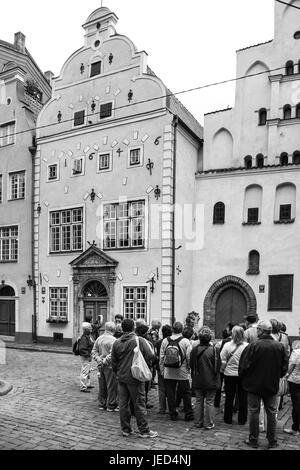 RIGA, LATVIA - SEPTEMBER 10, 2008: tourists on Maza Pils iela street near medieval houses (The three brothers) in Old Riga town in autumn. Riga city h Stock Photo