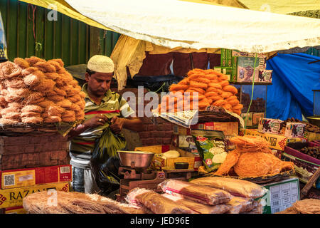 New Delhi, India. 23rd June, 2017. On last day of Ramadan a islamic festival. A vendor is busy at his counter and waiting for customers. People from different parts of India gathered at Jama Masjid for the celebration of Laylat-al-Kadr. Credit: Swapan Banik/Alamy Live News Stock Photo