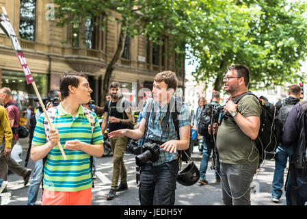 London, UK, 24th June 2017. Unite Against Fascism (UAF) has organized a demonstration near Trafalgar Square against the English Defence League (EDL).  A protester is arguing with photo press. Due to recent terrorist attacks, there’s a heavy police presence. Credit: onebluelight.com/Alamy Live News Stock Photo
