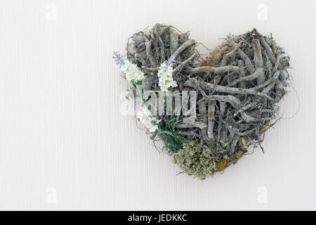 Wooden sprigs in the shape of heart on a white background. Isolate. Stock Photo