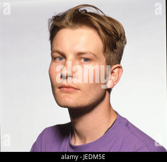 Portrait of a young man in a purple t shirt Stock Photo