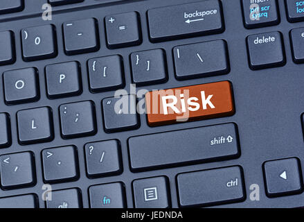 Risk word on computer keyboard button Stock Photo