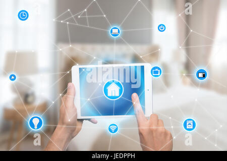 Smart home automation app on tablet with home interior in background. Internet of things concept Stock Photo
