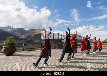 Georgian people in local dresses perform georgian folk dance, Georgia, Caucasus Mountains. Stock Photo
