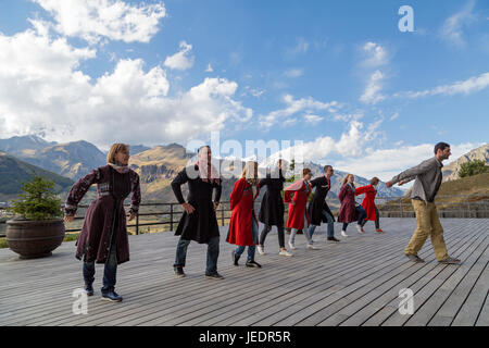 Georgian people in local dresses perform georgian folk dance, Georgia, Caucasus Mountains. Stock Photo