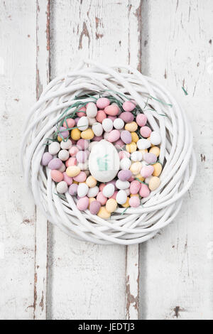 Chocolate Easter eggs and painted Easter egg in nest Stock Photo