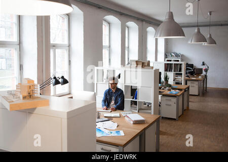 Man working at desk in office Stock Photo