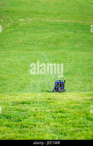 Two girls driving a Go Kart in a field on a farm in Virginia Stock Photo