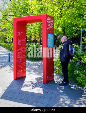 Berlin Volkspark Humboldthain park.Red arch 'Paradise is everywhere' information sign marks one of 8o green spots during IGA International Garden Show Stock Photo