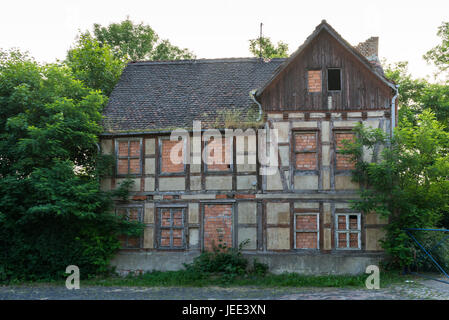 Facade of an uninhabited, decayed half-timbered house Stock Photo